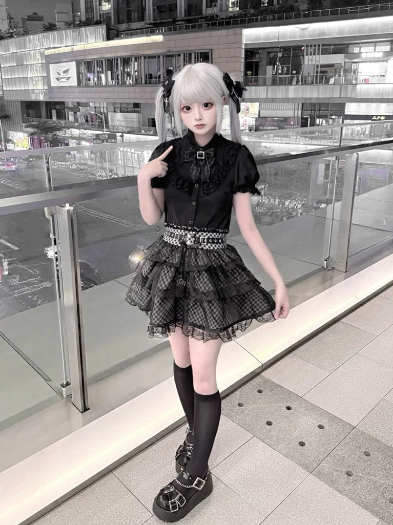 Jirai Kei black blouse plaid skirt front full-body view model hand near chin pose neat outfit silhouette outdoor location