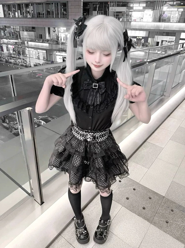 Jirai Kei black plaid skirt tulle overlay high-angle front view model with twin tails hairstyle layered skirt structure visible outdoor location
