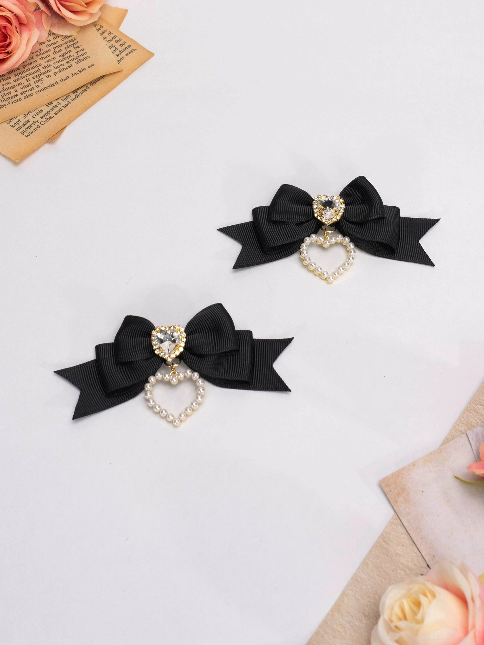 Simple black Jirai Kei satin bow hair clips with rhinestone center and hollow pearl heart pendant pair