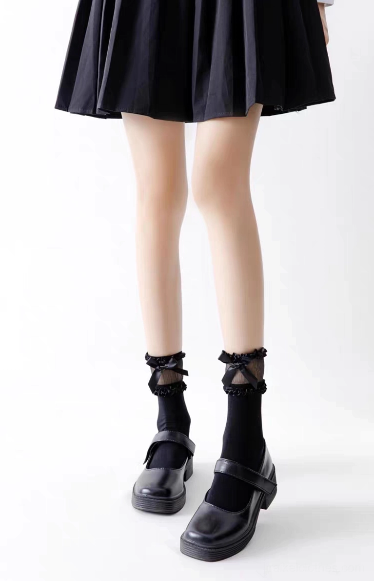 Black short ankle-length lolita socks with simple ruffled cuff design and solid color body styled with black Mary Jane shoes