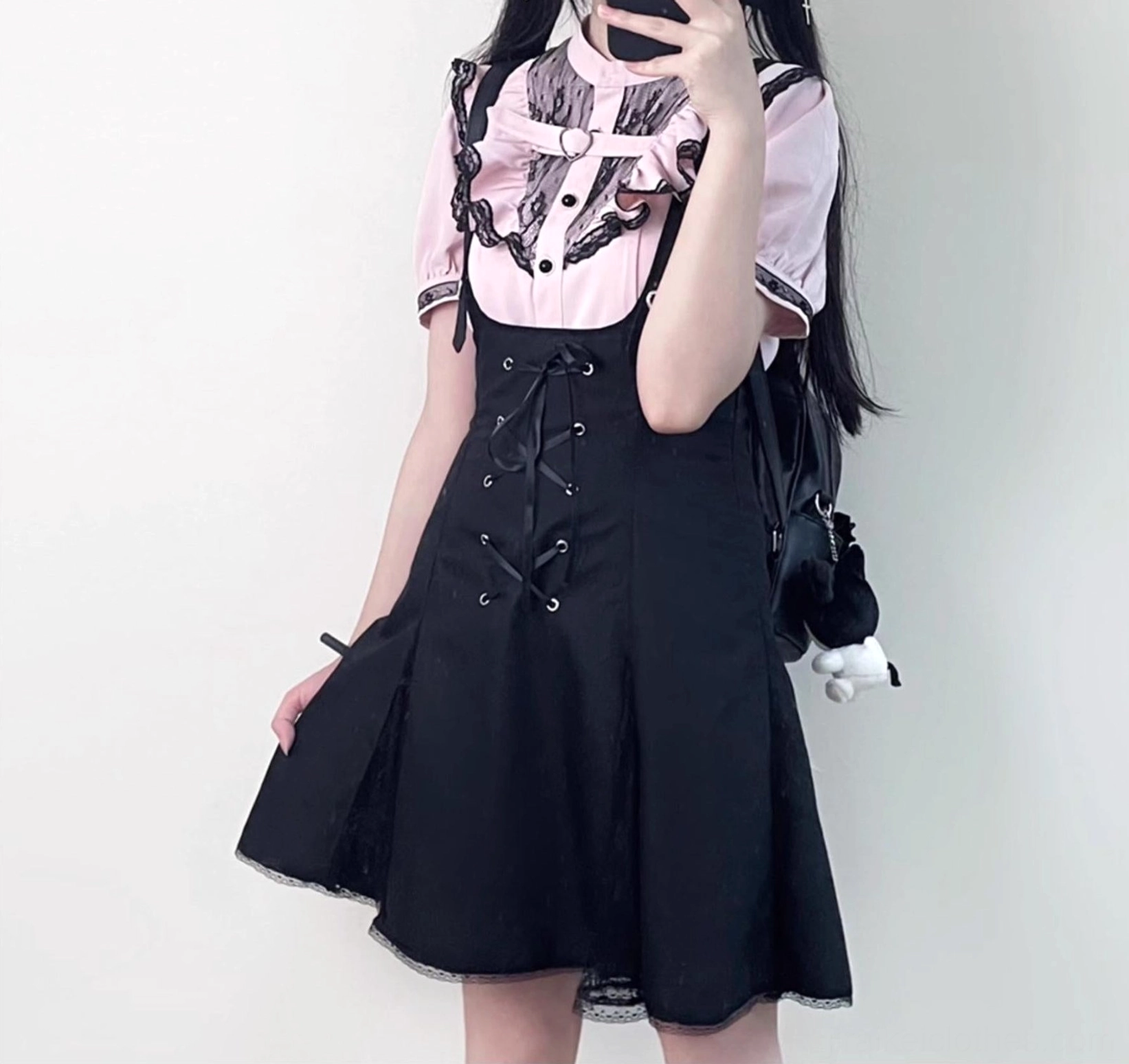 Black suspender skirt jirai kei style with adjustable shoulder straps lace-up front and A-line silhouette