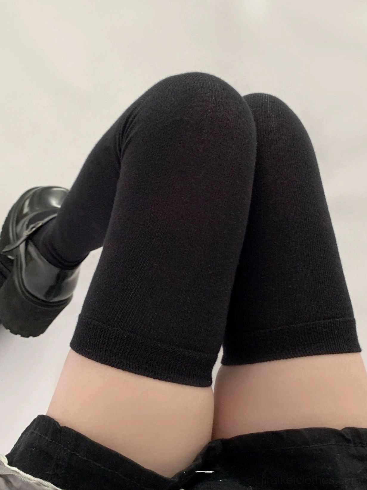Jirai Kei black thigh-high socks close-up seated position pure black smooth knit texture platform leather shoe