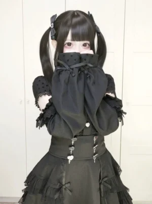 Black Jirai Kei lolita tiered ruffled skirt front view model with hands near face wearing bubble cuff sleeves dark aesthetic