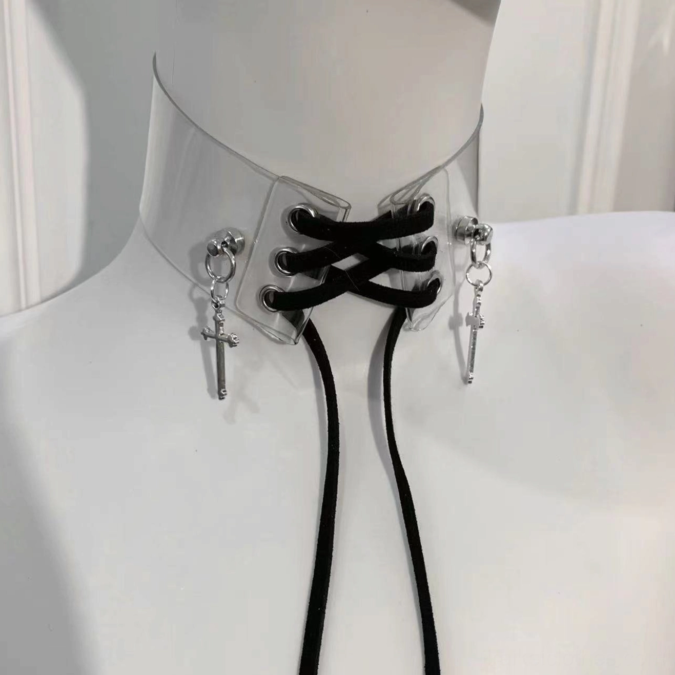Side-front perspective of black Jirai Kei choker featuring transparent design and adjustable criss-cross lace straps with silver crosses