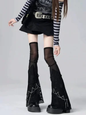 Black tulle chain over-knee leg warmers with spider web mesh embroidery detail front view on model wearing Y2K streetwear style outfit