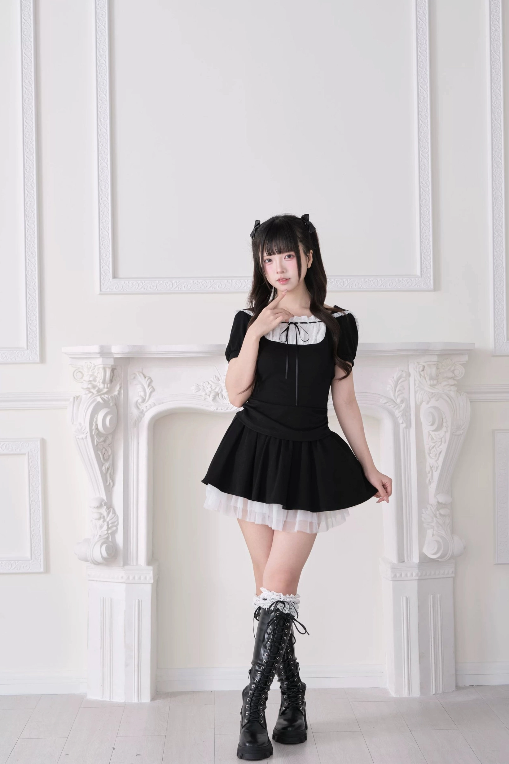 Black Jirai Kei two-piece set three-quarter front angle showing white tulle hem, puff short sleeves, ruffled collar with front bow