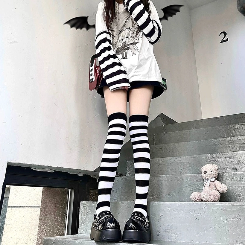 Black and white striped over-the-knee socks full body outfit styling guide, mini skirt platform shoes punk aesthetic