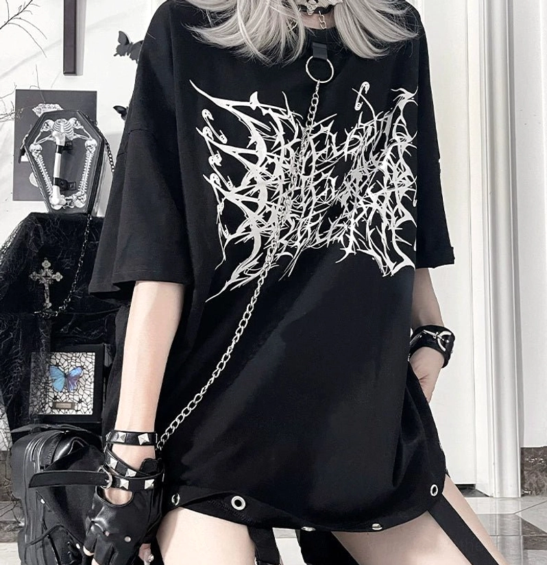 Close-up half-body shot of black Jirai Kei t-shirt with white thorn print, metal eyelet hem details and detachable chain collar