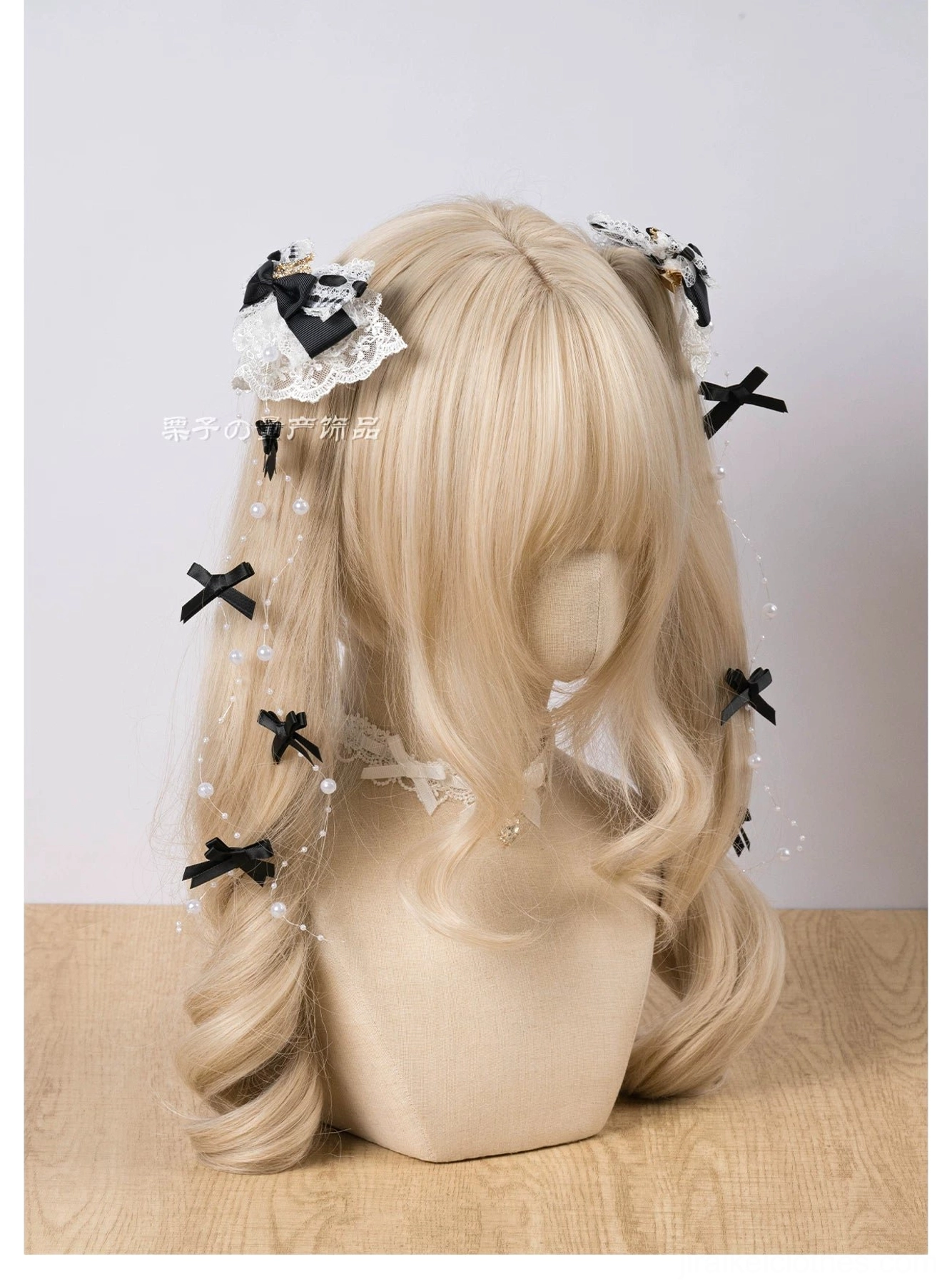 Dual Jirai Kei lace hair clips on blonde twin tail wig mannequin showing black-white bow with pearl chains and tiny bows