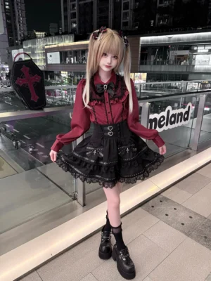 Full-length front view of wine-red long-sleeved Jirai Kei blouse paired with black tiered cake-styled lace skirt on nighttime commercial terrace, showcasing complete two-piece outfit aesthetic