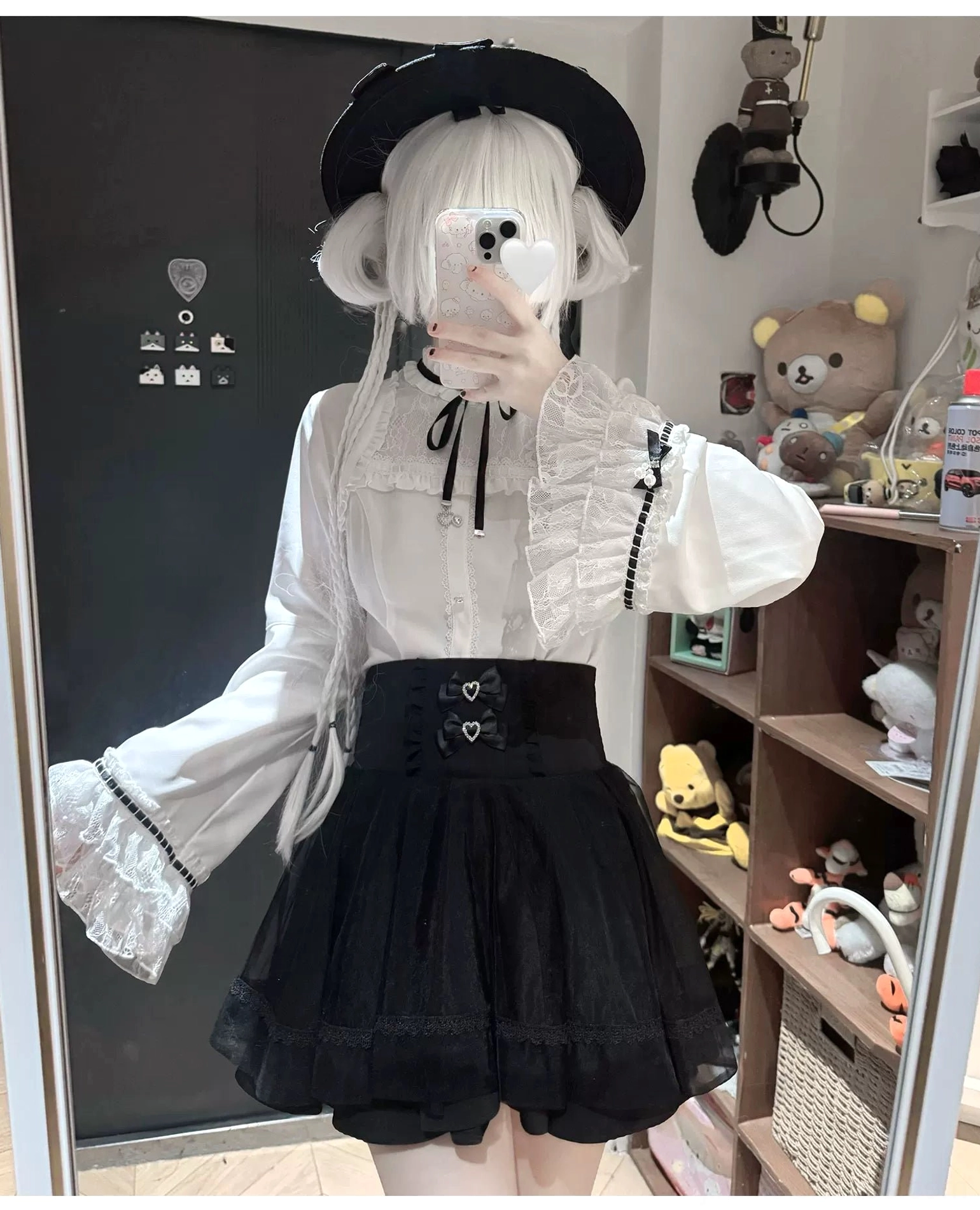 Jirai kei blouse with black ribbon bow neckline, heart-shaped button closure, and lace-trimmed collar and cuffs detail shot for subcultural fashion appreciation