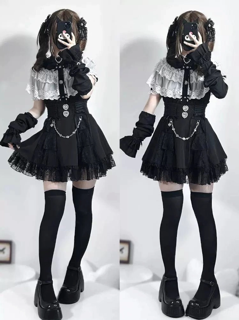 Black and white Jirai Kei blouse two-piece outfit with twin models in mirror selfie view showing short sleeves and ruffle details