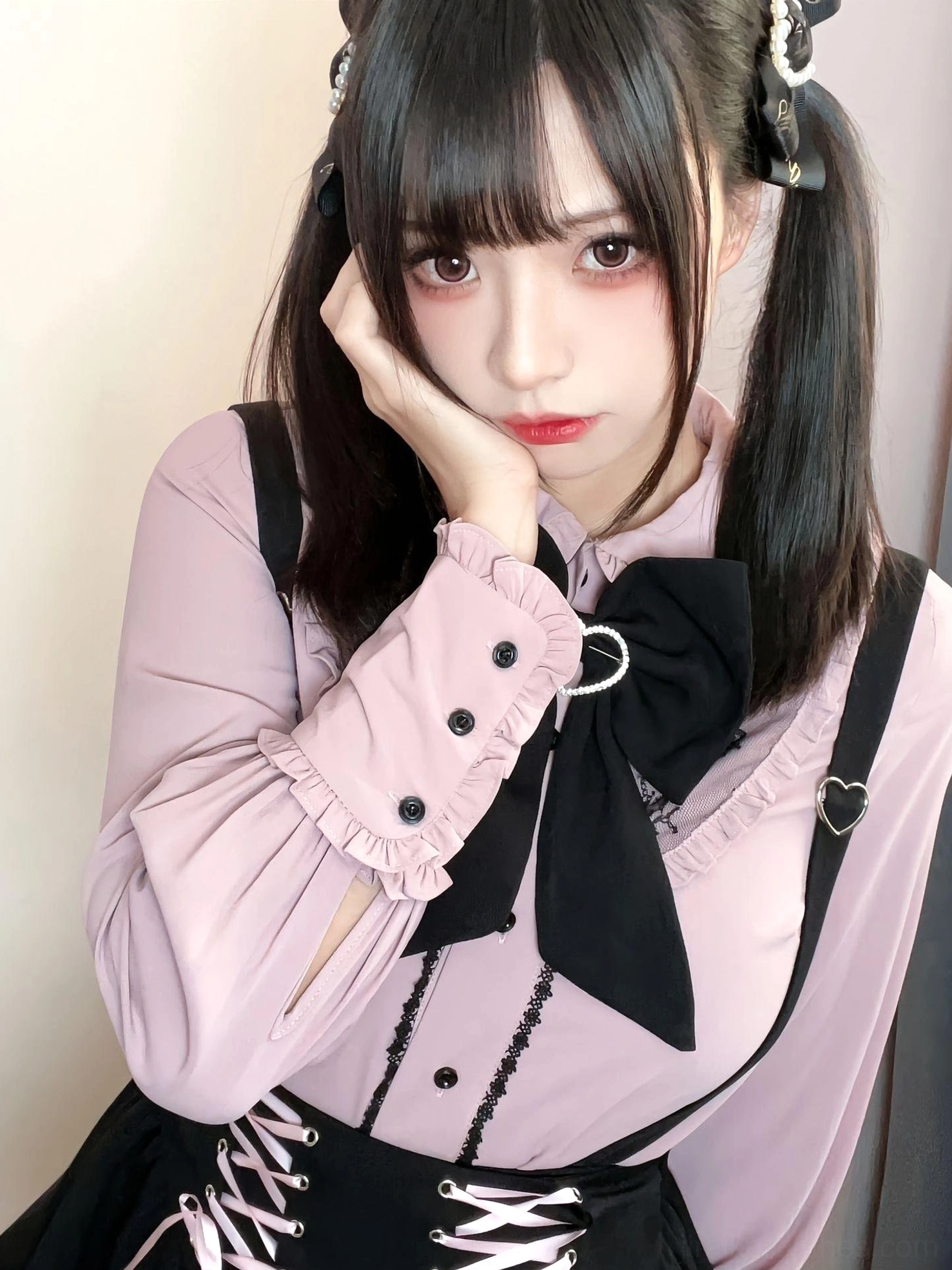Close-up detail shot of Jirai Kei blouse featuring black bow tie, ruffled cuffs, heart-shaped buckle, lace-up waist detail, twin-tailed model