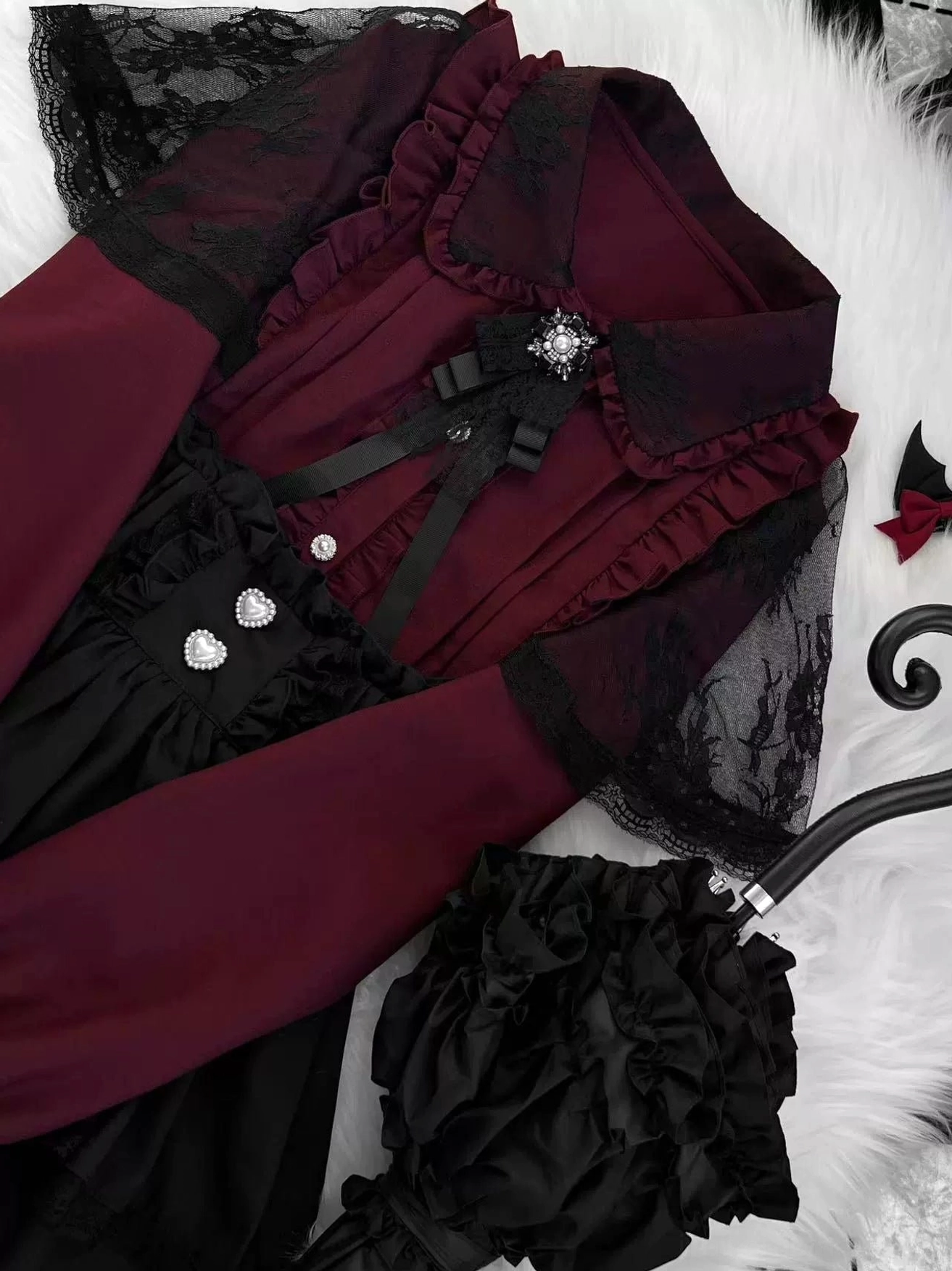 Jirai Kei burgundy lace blouse close-up detail view showing pearl buttons satin ribbon bow lace ruffled trim