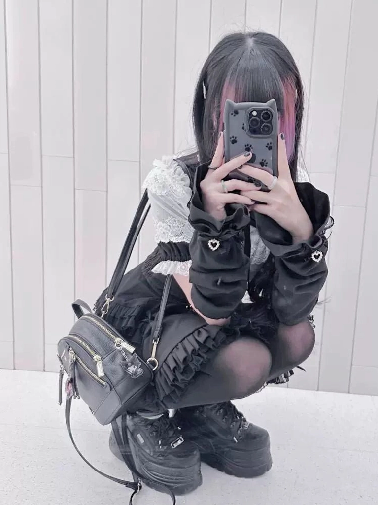 Casual daily Jirai Kei blouse outfit with lace collar matching cropped jacket and platform boots in crouching selfie view