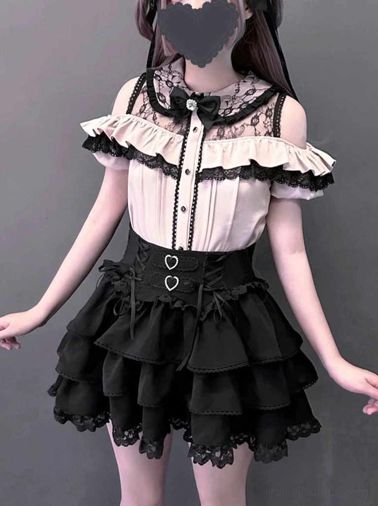 Close-up half-body view of Jirai Kei Gothic lolita blouse and skirt against plain background showing lace collar yoke, ruffled trims, heart-shaped waist decorations, and tiered ruffled skirt construction