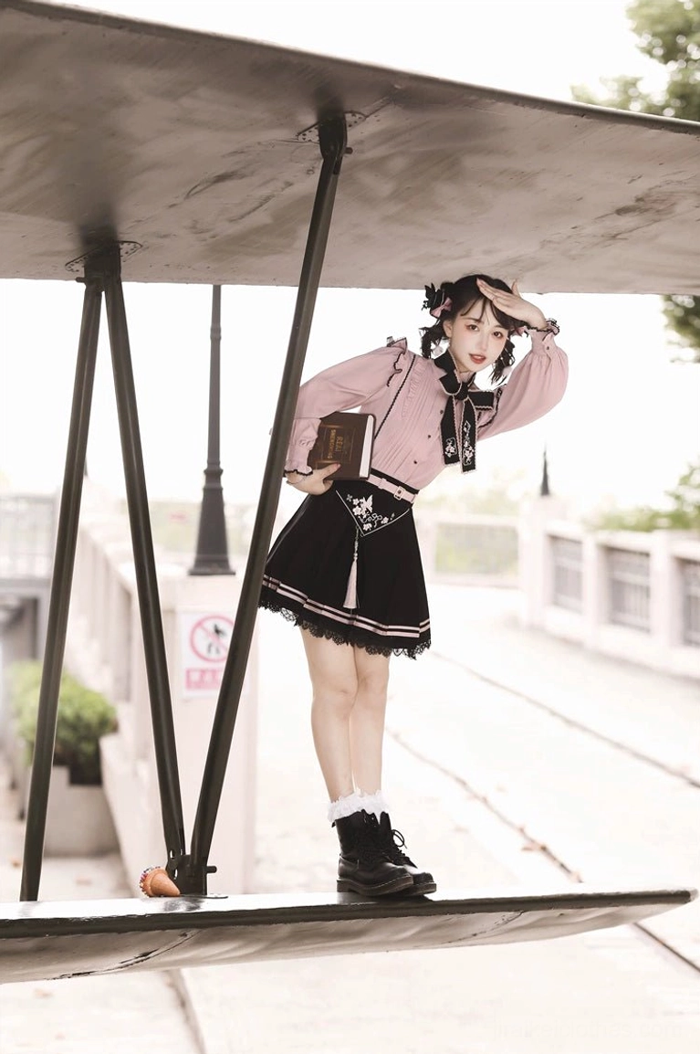 Jirai Kei pink blouse and black skirt set detail shot highlighting embroidered Chinese floral motif, pleated design, and color blocking aesthetic