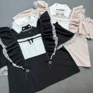 Two-tone Jirai Kei maid blouses flat lay top-down view showing black and pink variants with lace ruffles detachable collars and small heart bow embellishments off-shoulder design