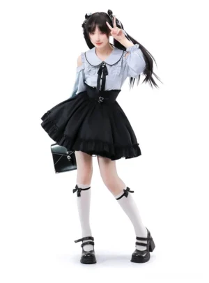 Celestial blue cold-shoulder blouse with voluminous sleeves and Peter Pan collar paired with black multi-layer ruffled skirt, complete Jirai Kei gothic lolita two-piece ensemble on twin-tailed model in studio setting
