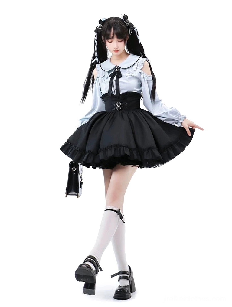 Three-quarter view of complete Jirai Kei ensemble with light blue cold-shoulder blouse, black decorative ruffle skirt with silver heart buckles, vertical mini shoulder bag styling