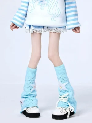 Full length lower body shot of sky blue Jirai Kei leg warmers styled with striped knit top and white lace mini skirt, showcasing hollow knit design and star embellishments against white studio background