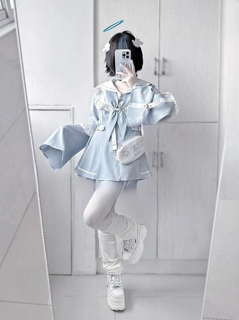Side profile view of model wearing light blue sailor Jirai Kei dress and shorts set demonstrating adjustable side waist buckle and zipper closure details