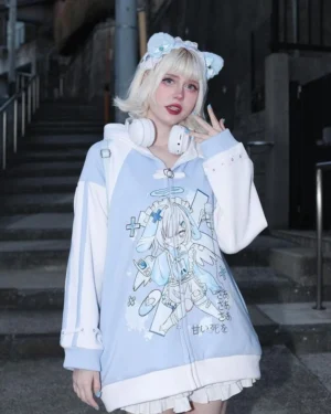 Blue and white color block bunny ear hoodie waist up front shot with cat ear headband and white headphones worn by blonde model