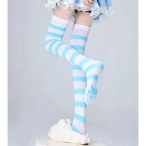 Blue white horizontal striped thigh-high socks front view with cat paw sole detail, styled with blue lace skirt and white platform shoes
