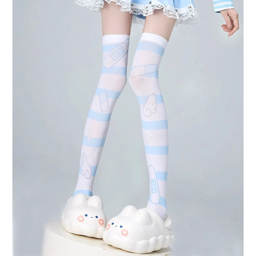 Side-front leg view of model in blue-white striped printed over-the-knee socks featuring playful patterns, lace-trimmed skirt, bunny slippers aesthetic
