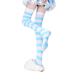 Blue and white striped Jirai Kei thigh-high socks worn with blue lace lolita skirt and white platform slippers, side-front view showing cat paw print on sock sole