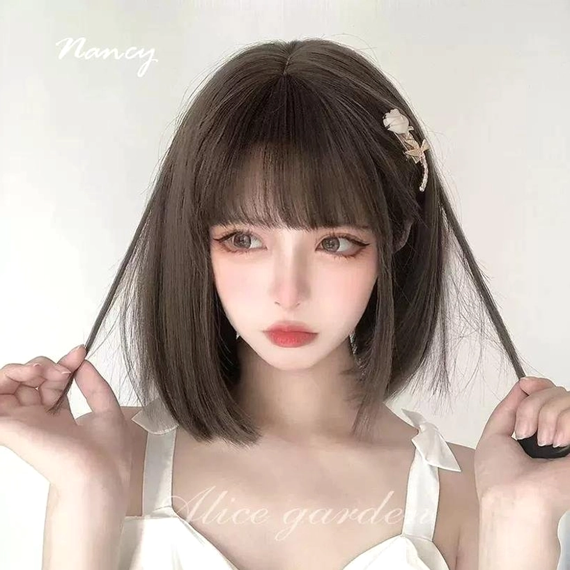 Jirai Kei short bob wig on model playing with hair strands front close-up with rose hairpin and camisole