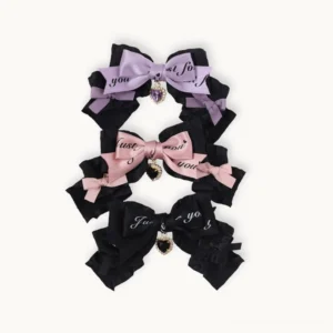 Three-color handmade Jirai Kei bow hair clips set layered design black purple pink with heart charm pendants flat lay display