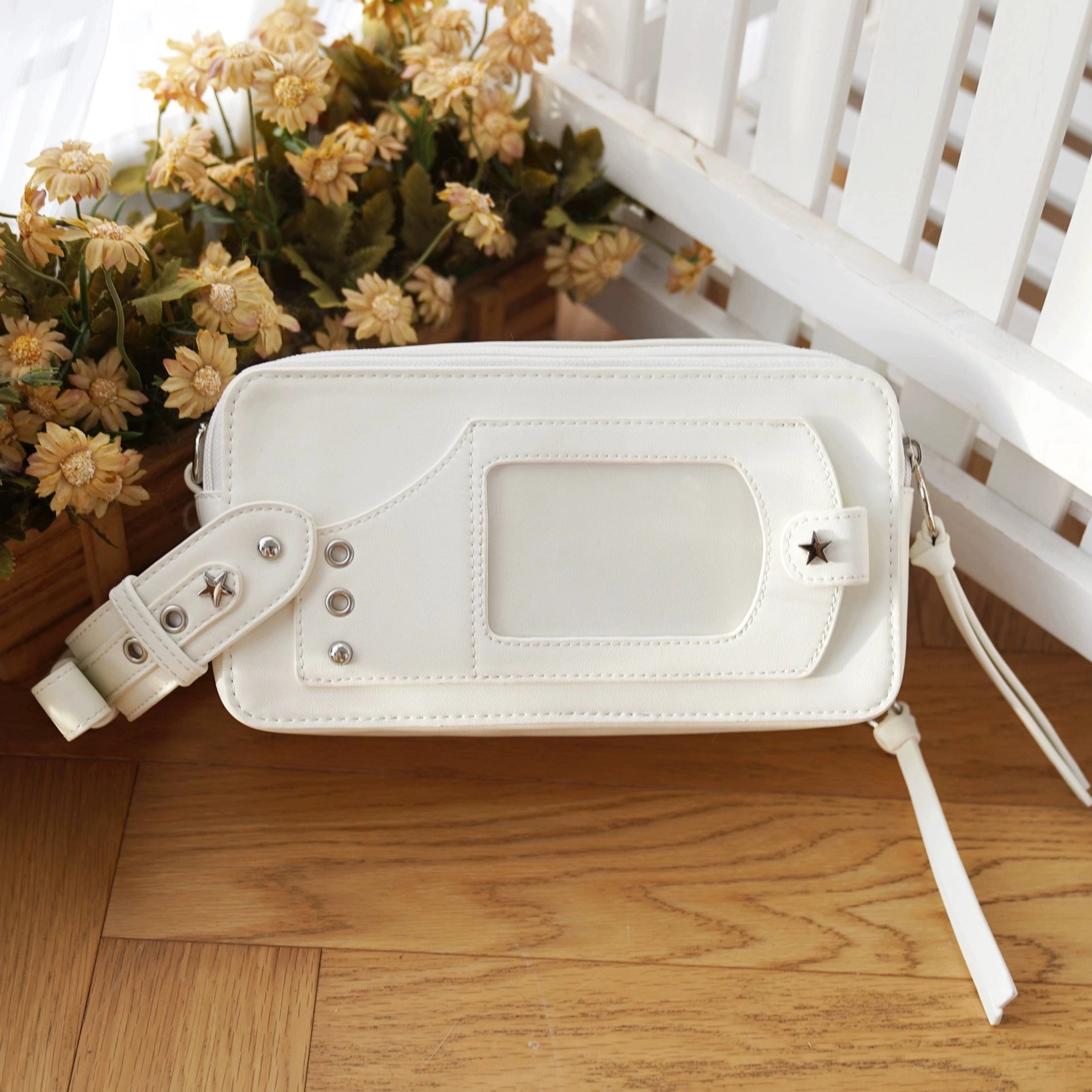 White jirai kei brick itabag side flat lay showing pure leather back pocket and tassel straps wooden floor decor
