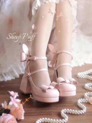 Jirai Kei light pink patent leather platform heels with front bow and bunny ear decoration worn with pearl socks and lace dress frontal view