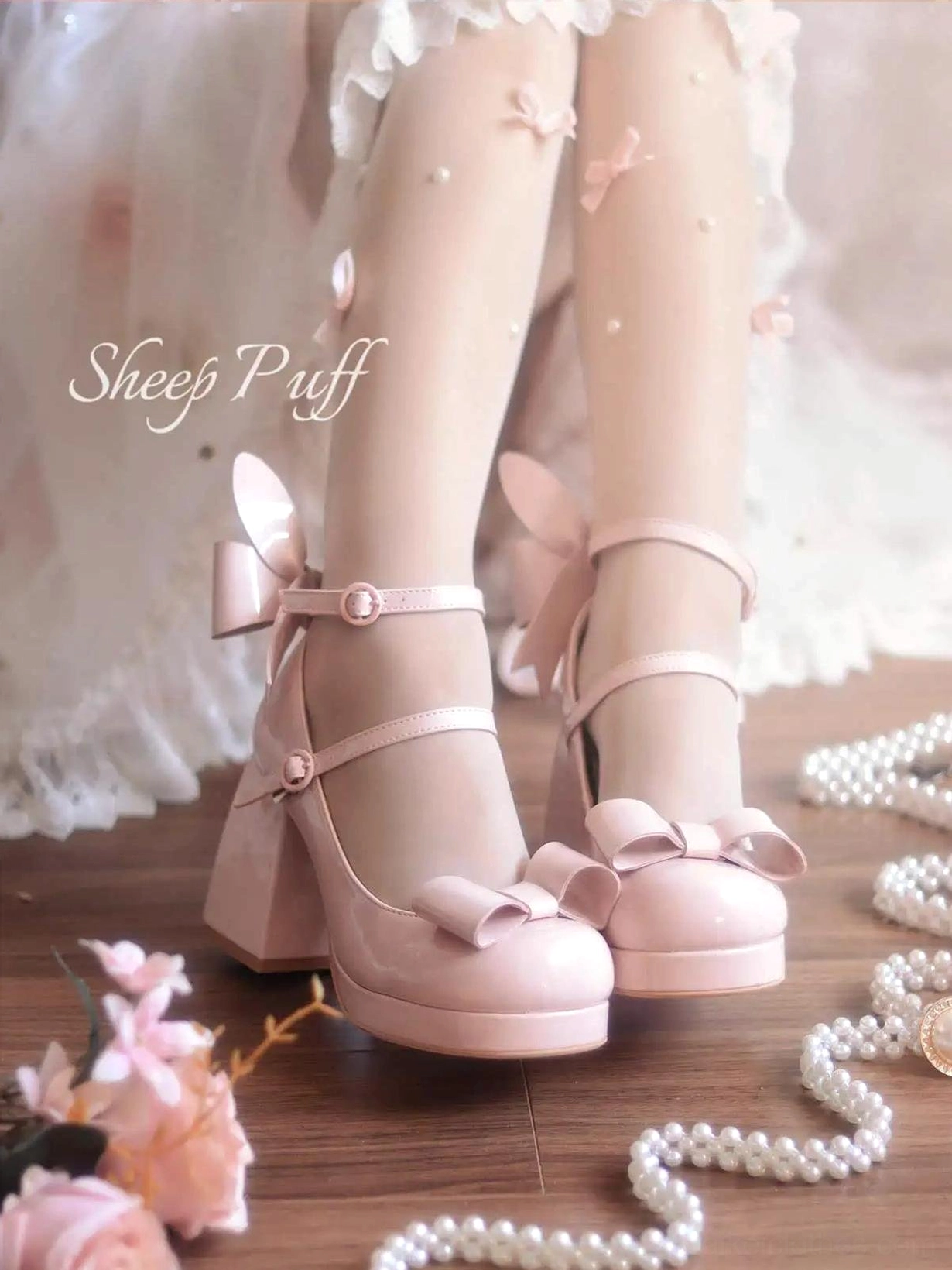 Jirai Kei light pink patent leather platform heels with front bow and bunny ear decoration worn with pearl socks and lace dress frontal view