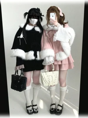 Sweet Jirai Kei bunny ear winter cape worn by model in front mirror selfie view showing black and pink colorways with fluffy white trims and removable bows