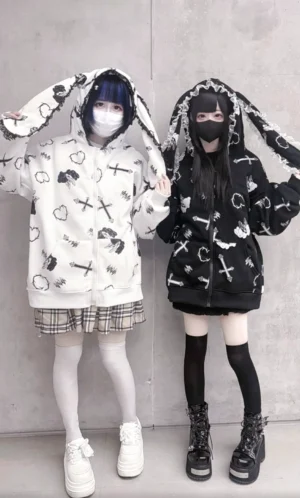 Full-body front view of Jirai Kei bunny ear hoodie jacket on two subcultural models, highlighting lace-trimmed hood ears and pullable bunny ear details