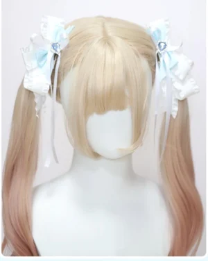 Jirai kei butterfly hair clips with heart rhinestones front overhead view on mannequin displaying bicolor white blue satin ribbons