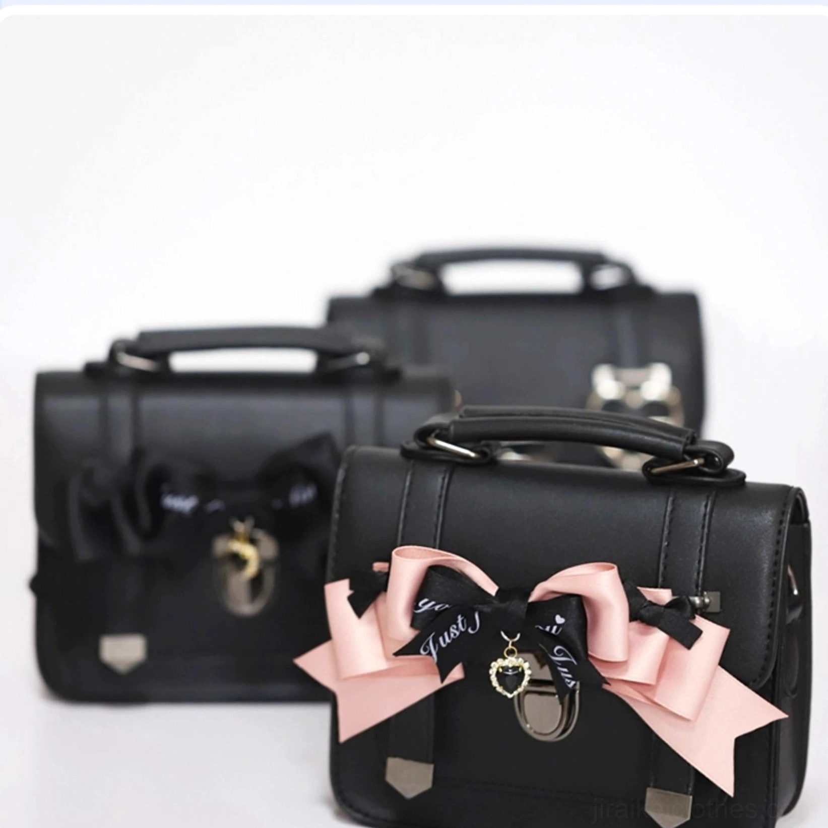 Flat display of three Jirai Kei Cambridge handbag style variations arranged on blue and white checkered background showing pink bow, black bow, and heart buckle options