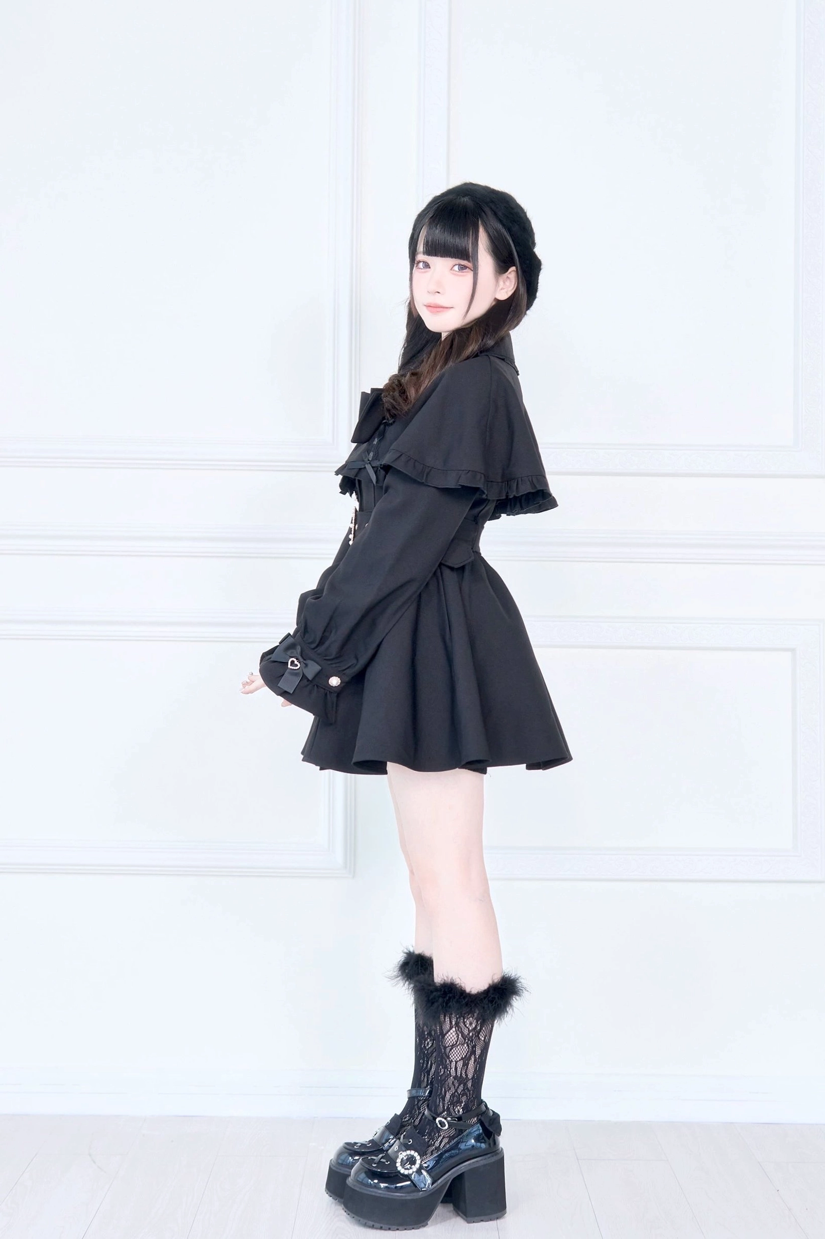 Cape trench coat close-up detail shot of lace accents ruffles and decorative elements on collar and cuffs