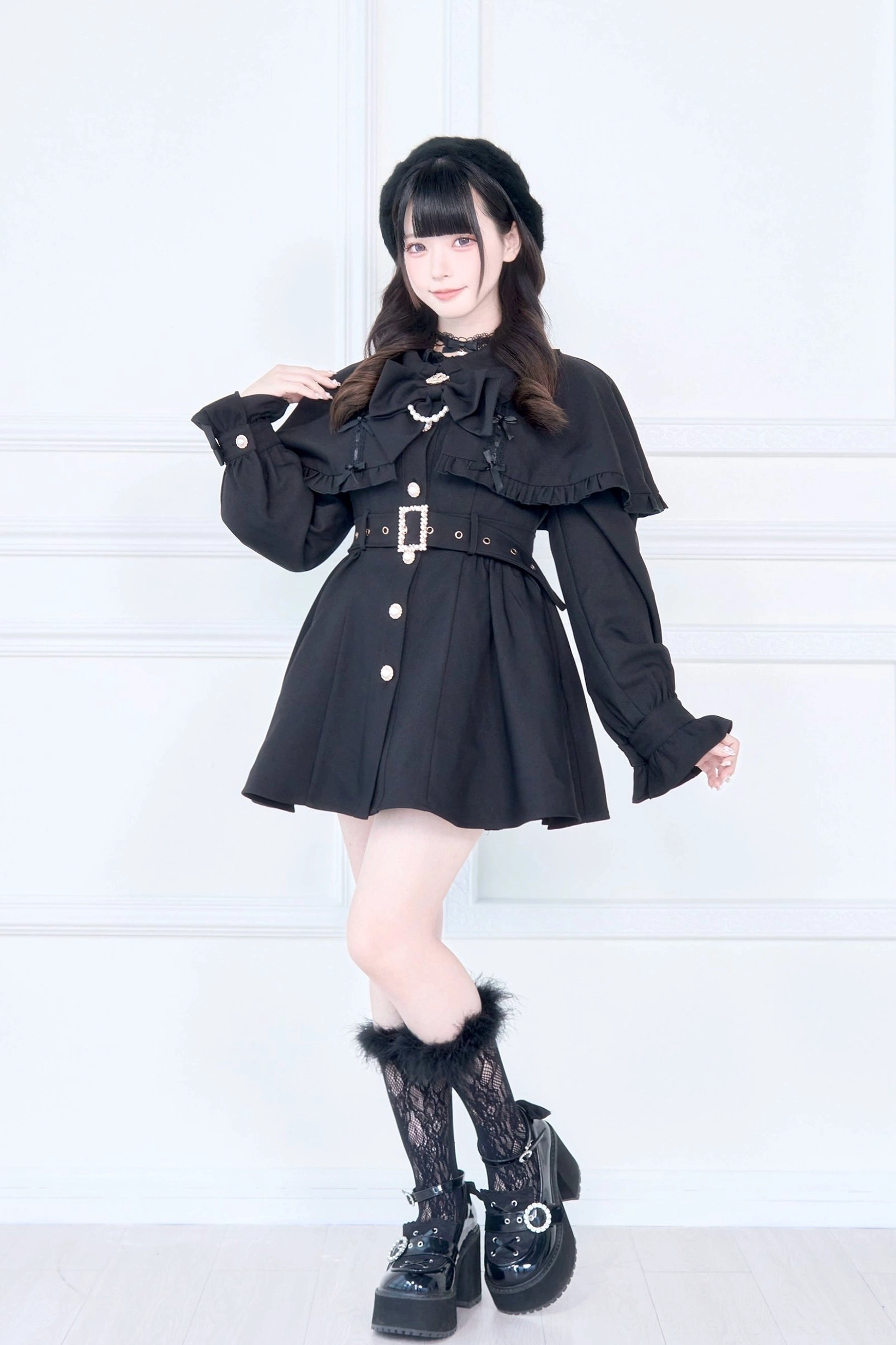 Cape trench coat sleeve and shoulder construction detail showing puff sleeve design and cape attachment point
