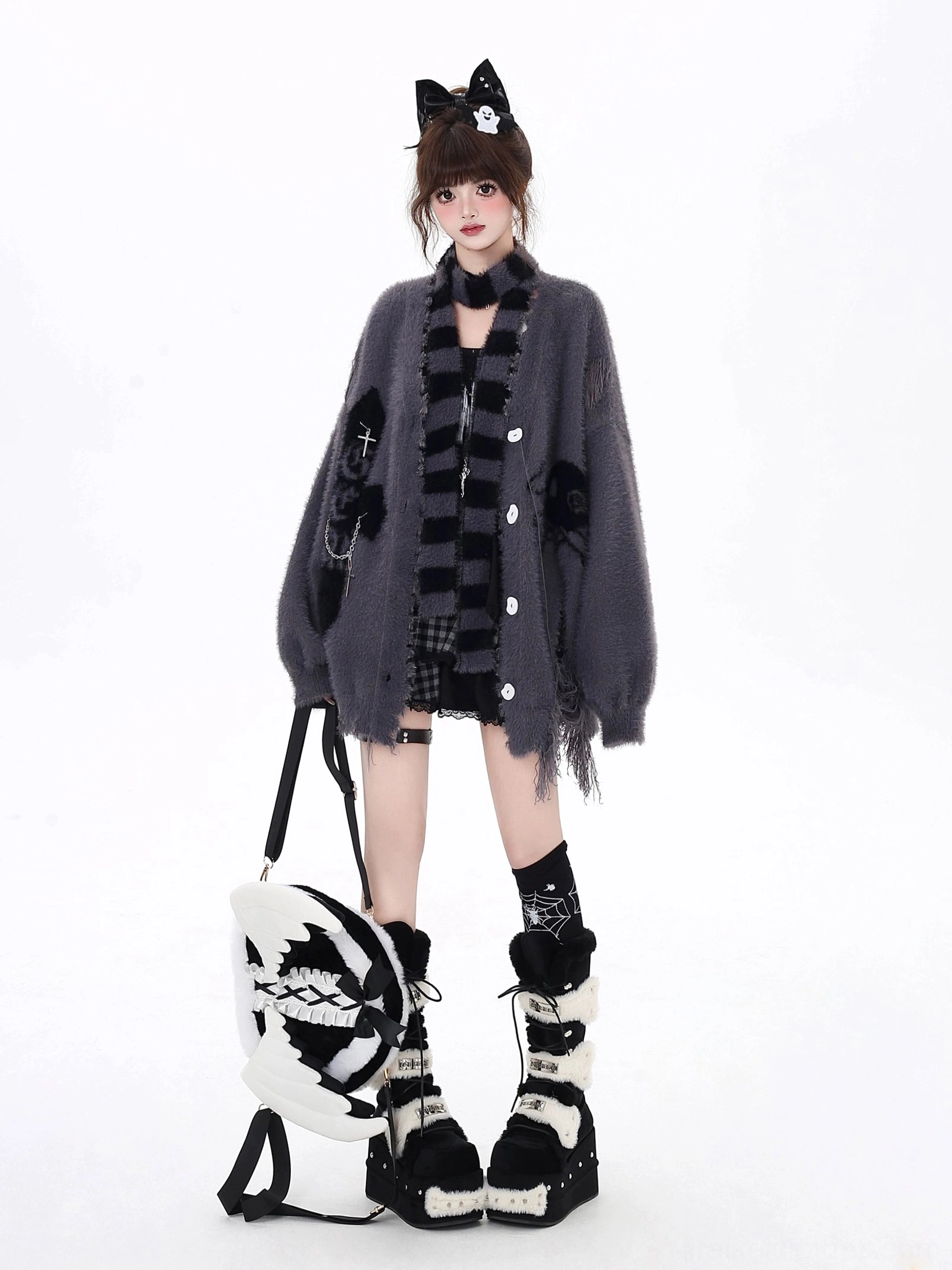 Jirai Kei distressed cardigan collection detail shot showcasing embroidered cross and skull motifs, irregular hem distressing, and fabric texture of oversized fit cardigan