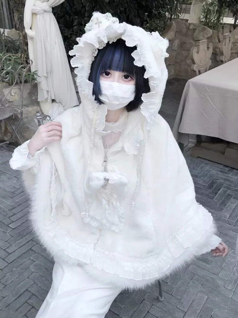 Ruffle trim and hem detail on jirai kei cat ear fleece cape coat showing Victorian-inspired lace accents and decorative edges