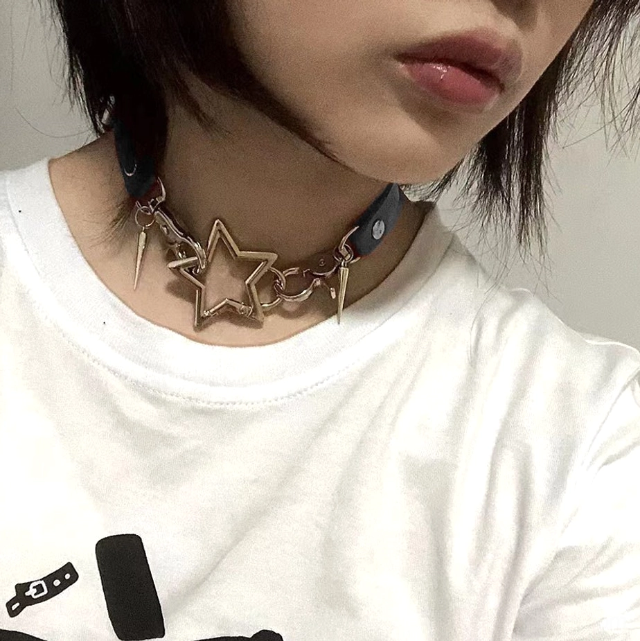 White and black Jirai Kei choker necklaces styled together showing dual punk aesthetic bone and star pendants