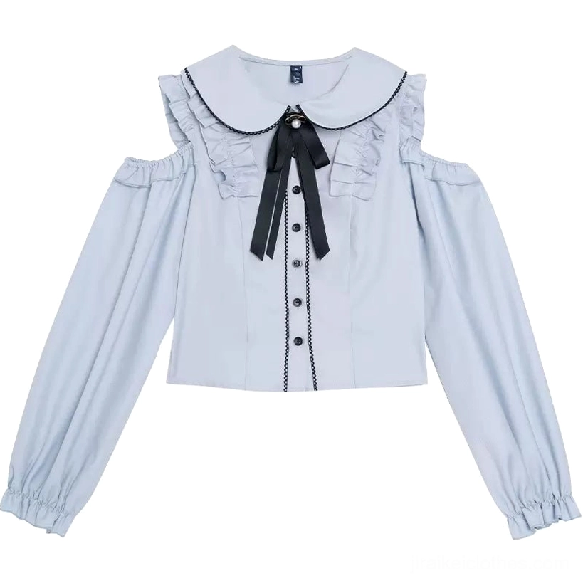 Flat lay detailed view of celestial blue cold-shoulder blouse showcasing Peter Pan collar with black lace trim, button-front closure, ruffled shoulders, and decorative ribbon bow