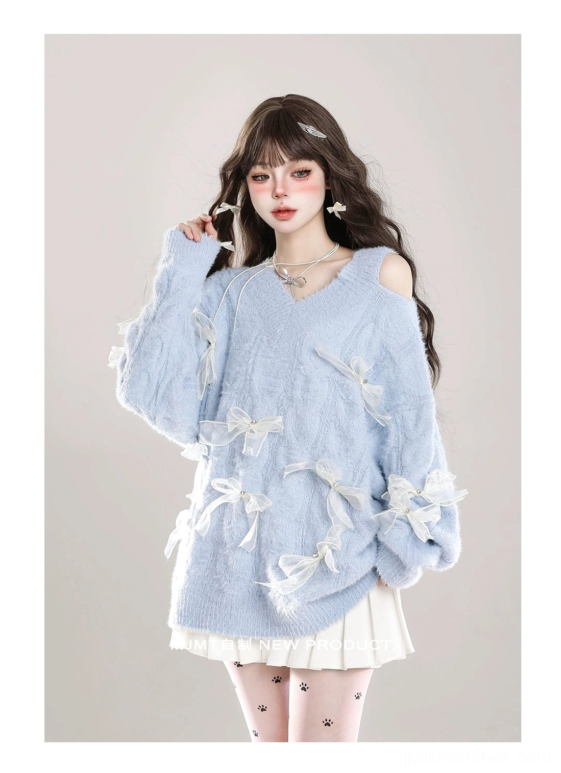 Jirai Kei cold-shoulder fuzzy bow sweater detail shot showing white ribbon bow construction, V-neck asymmetrical neckline, and plush knit texture