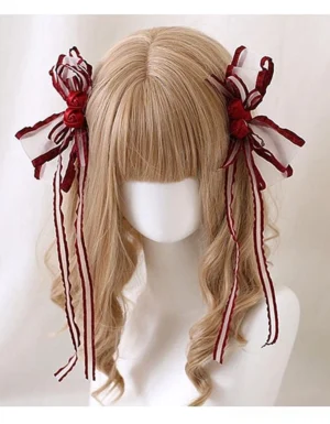 Dark burgundy Jirai Kei hair clips with red rose design and ribbon streamers on light brown curly hair mannequin portrait