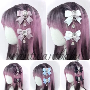Jirai Kei bow hair clips styled on mannequin heads with gradient pink purple hair showing double-layer bow construction and dangling heart charms
