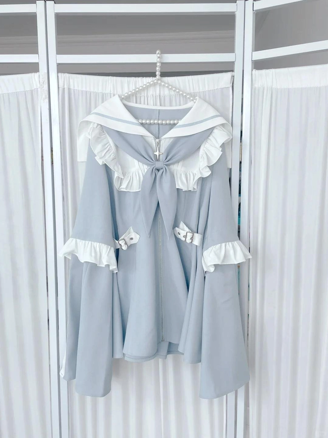 Detail shot of adjustable side waist buckle and zipper closure mechanism on pastel blue sailor Jirai Kei dress showing functional design elements