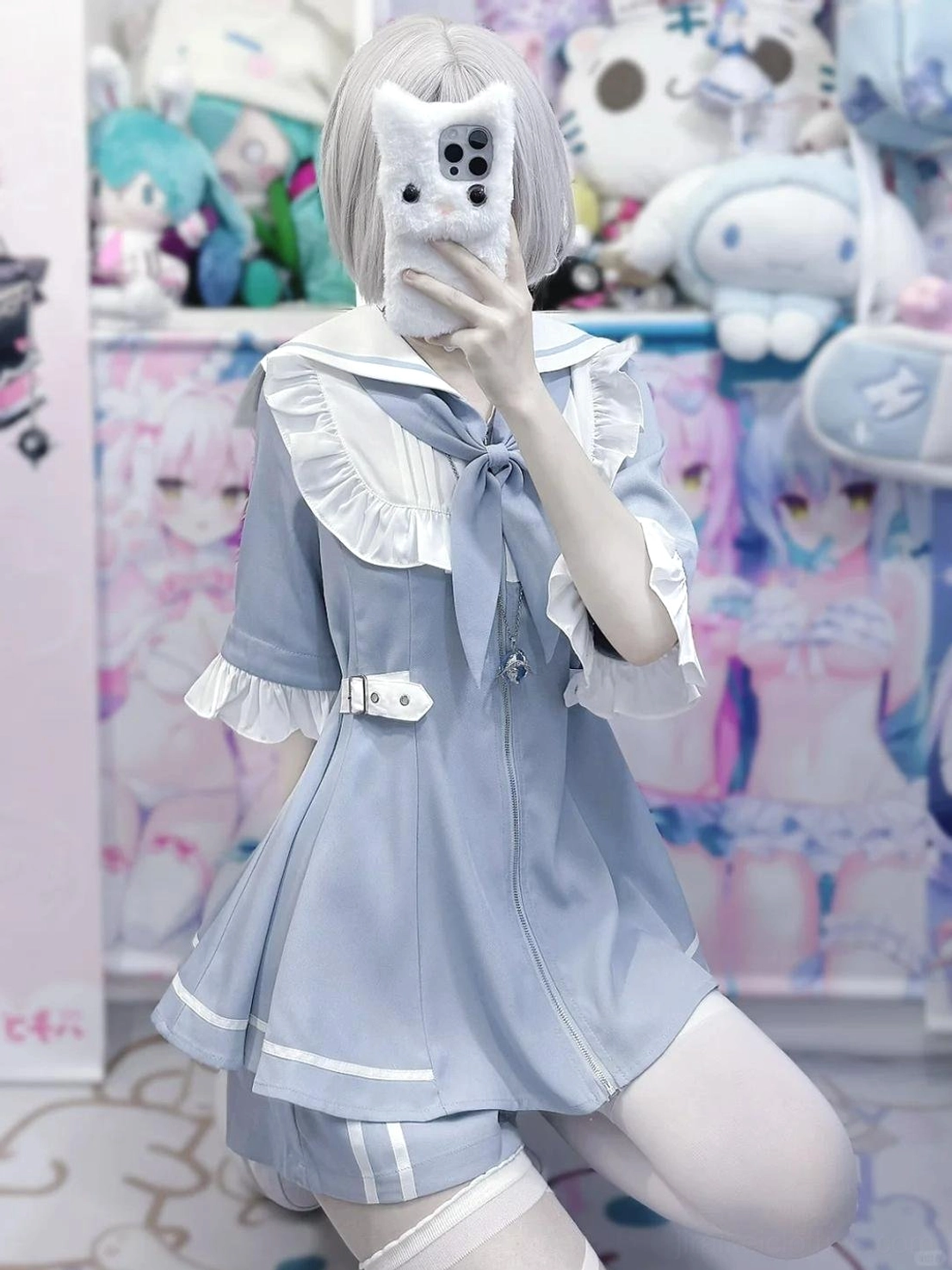 Detailed close-up view of pastel blue sailor Jirai Kei dress highlighting white pleated lace trim, ruffled collar construction, and front bow embellishment